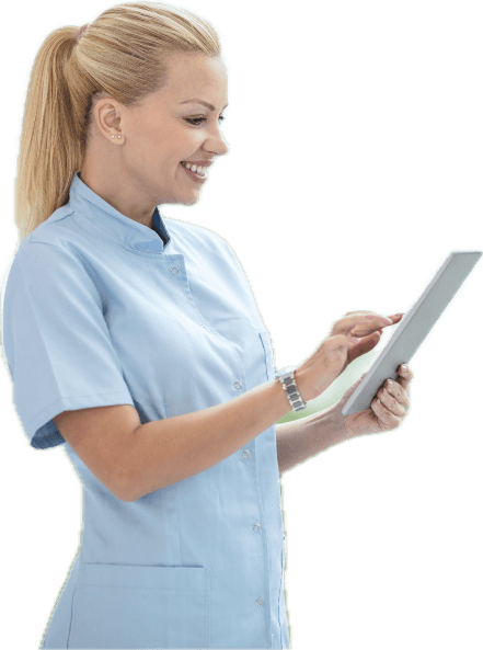 Smiling nurse in scrubs using a tablet